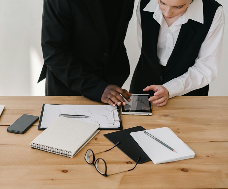 Professionals reviewing notes and a tablet during a work session